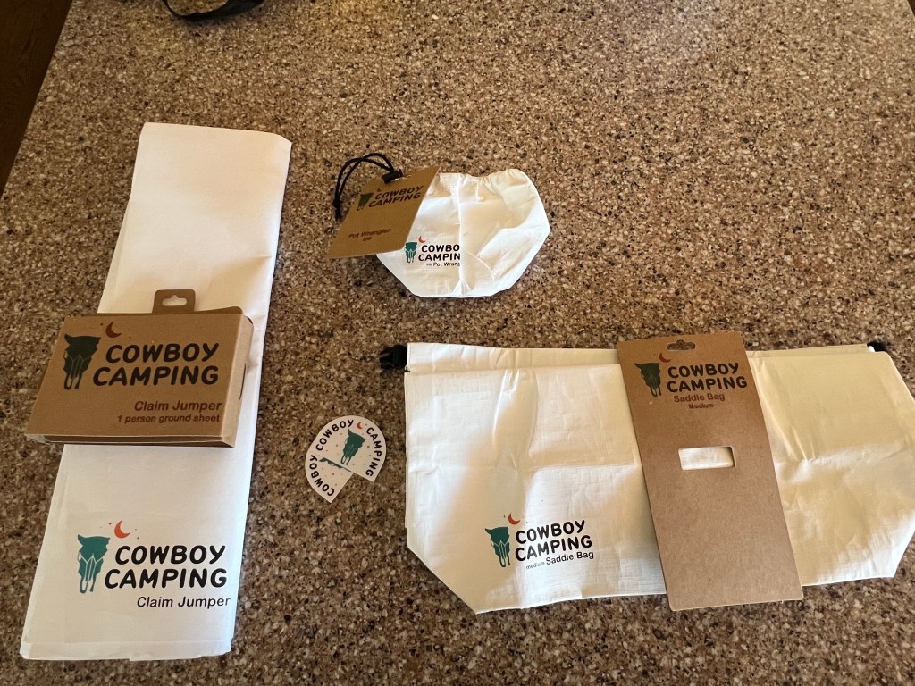 Three items from Minimal Gear's Cowboy Camping line of camping accessories
